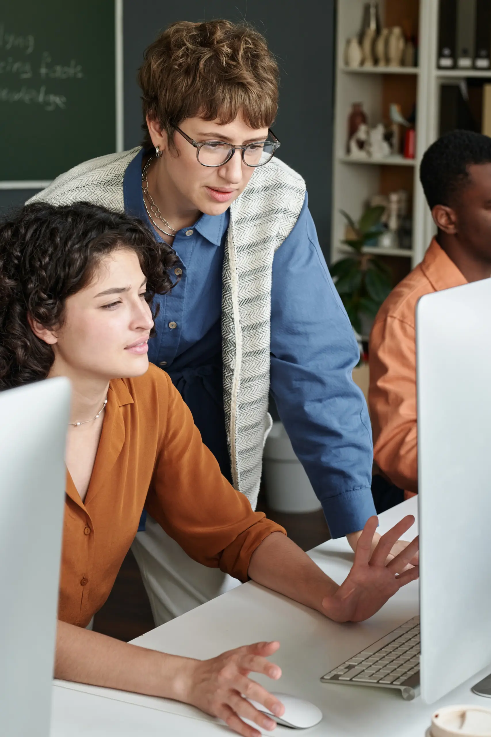 People working on computer to put together a Google ad campaign