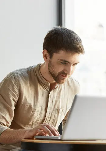 Web designer in Lübeck building a website on his laptop for a client