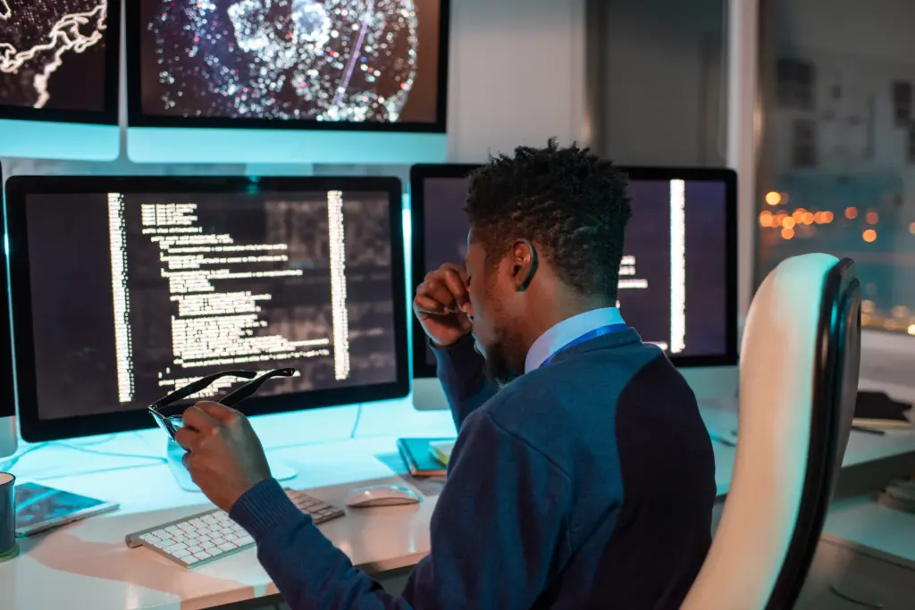 Frustrated web developer struggling with schema markup and technical SEO implementation on multiple screens